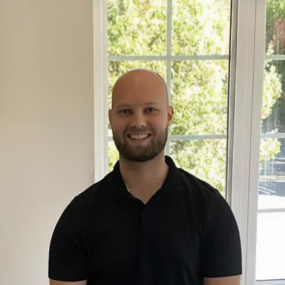 Chiropractic London ON Joel About Massage Therapist Joel Smiling In Collared Shirt